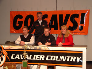Ross Homan, seated center, officially signed his national letter-of-intent to play football for The Ohio State University on Wednesday, having already graduated from Coldwater and enrolled in the Winter Quarter. Seated with Ross are parents Dave and Alice Homan. Coldwater head coach John Reed looks on from the back. Homan returned to Coldwater from classes at OSU on Wednesday to attend a signing ceremony for not only himself, but for teammates Brady Geier and Cody Muhlenkamp, who signed to play at Dayton and Ball State respectively.<br></br>dailystandard.com