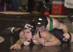 Celina's Nick Gray, top, tries to finish off his match against Coldwater's Gregg Homan, bottom, during their match at 130 pounds on Saturday at the 17th Celina Lions Wrestling Invitational. Gray won his bout and won the weight class.<br></br>dailystandard.com