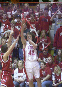 St. Henry's Tyler Post, 42, launches a three-point shot over a New Knoxville defender in the final seconds before the end of the third quarter to start a game-changing Redskins run. St. Henry went on to defeat New Knoxville, 46-36.<br></br>dailystandard.com