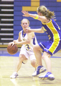 St. Marys' Toya Anderson, left, tries to find an opening against the defense of Marion Local's Maria Moeller, right, during their nonconference battle at McBroom Gymnasium on Tuesday night. Marion Local defeated St. Marys, 49-37.<br></br>dailystandard.com