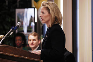Katy Dicke, with husband James Dicke III, in the background, presents a $2 million check to help fund the construction and renovation project at Wright State University-Lake Campus.<br></br>dailystandard.com