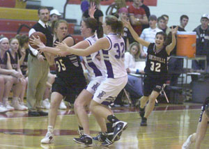 Fort Recovery's Abby Niekamp, middle, and Holly Stein, 32, trap a Spencerville player during their Division IV sectional semifinal contest on Tuesday at Cardinal Gymnasium in New Bremen. Fort Recovery coasted past Spencerville, 63-30.<br></br>dailystandard.com