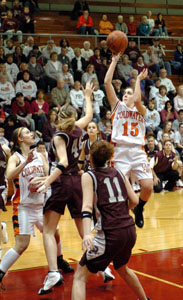Coldwater's Tasha Stucke, 15, hangs in the air during a shot against a pair of Paulding defenders during the Division III sectional final on Saturday night. Coldwater defeated Paulding, 39-30.<br></br>dailystandard.com