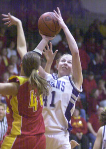 Fort Recovery's Tiffany Gaerke, with ball shoots over New Bremen's Sarah Schmiesing, in red, during their Division IV district semifinal contest at The Palace in Coldwater. Fort Recovery defeated New Bremen, 56-41.<br></br>dailystandard.com