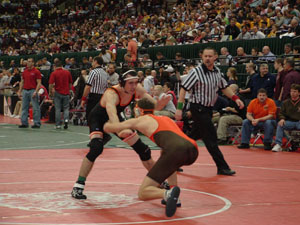 Coldwater's Andy Schmidt, in back, gets ready to engage with his opponent on Friday at the 69th State Wrestling Tournament in Columbus. Schmidt, who now holds the all-time win total in Coldwater school history, will be wrestling for seventh-place today.<br></br>dailystandard.com