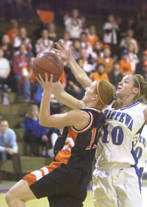 Coldwater's Renee Hemmelgarn, left, tries to shoot but is fouled by Chippewa's Chrissy Summers, 10, during their Division III regional semifinal contest on Wednesday night at Vandalia-Butler's Student Activity Center. The Cavaliers went on to defeat Chippewa, 50-34.<br></br>dailystandard.com