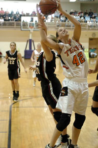 Versailles' Justine Raterman, 42, gets fouled by a Jonathan Alder player during their Division III regional final at Vandalia-Butler's Student Activities Center on Saturday. Jonathan Alder defeated Versailles, 45-41.<br></br>dailystandard.com