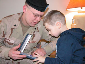 Greg Meier shows his son, Kollynn, the Purple Heart he recently received for wounds and heroism while serving in Iraq in 2004. The medal is scheduled to be honorably pinned on the Maria Stein native during a special presentation Tuesday at the Statehouse in Columbus.<br></br>dailystandard.com