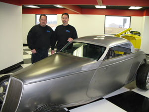 Standing beside a prototype Coopster that will be built at Hagan Street Rods in New Bremen are owners J.D. Hagan, left, and Pete Hagan. The business, which has customers throughout the United States and overseas, moved to Bunker Hill Industrial Park in January from its previous Carson City, Nev., location.<br></br>dailystandard.com