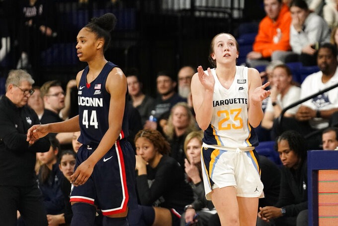 Marquette's Jordan King (23) claps in front of UConn's Aubrey Griffin (44) during the second half of an NCAA college basketball game Wednesday, Feb. 8, 2023, in Milwaukee. (AP Photo/Aaron Gash)
