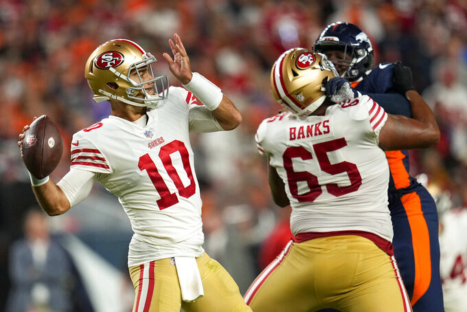 San Francisco 49ers quarterback Jimmy Garoppolo (10) passes against the Denver Broncos during the first half of an NFL football game in Denver, Sunday, Sept. 25, 2022. (AP Photo/Jack Dempsey)