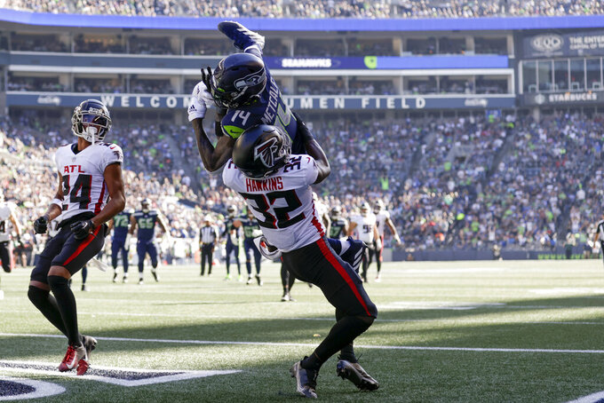Seattle Seahawks wide receiver DK Metcalf, above, makes a catch in the end zone for a touchdown as Atlanta Falcons safety Jaylinn Hawkins defends during the first half of an NFL football game Sunday, Sept. 25, 2022, in Seattle. (AP Photo/John Froschauer)