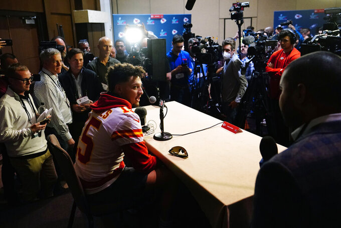 Kansas City Chiefs' Patrick Mahomes, center, answers a question during an NFL football Super Bowl media availability in Scottsdale, Ariz., Tuesday, Feb. 7, 2023. The Chiefs will play against the Philadelphia Eagles in Super Bowl LVII on Sunday. (AP Photo/Ross D. Franklin)