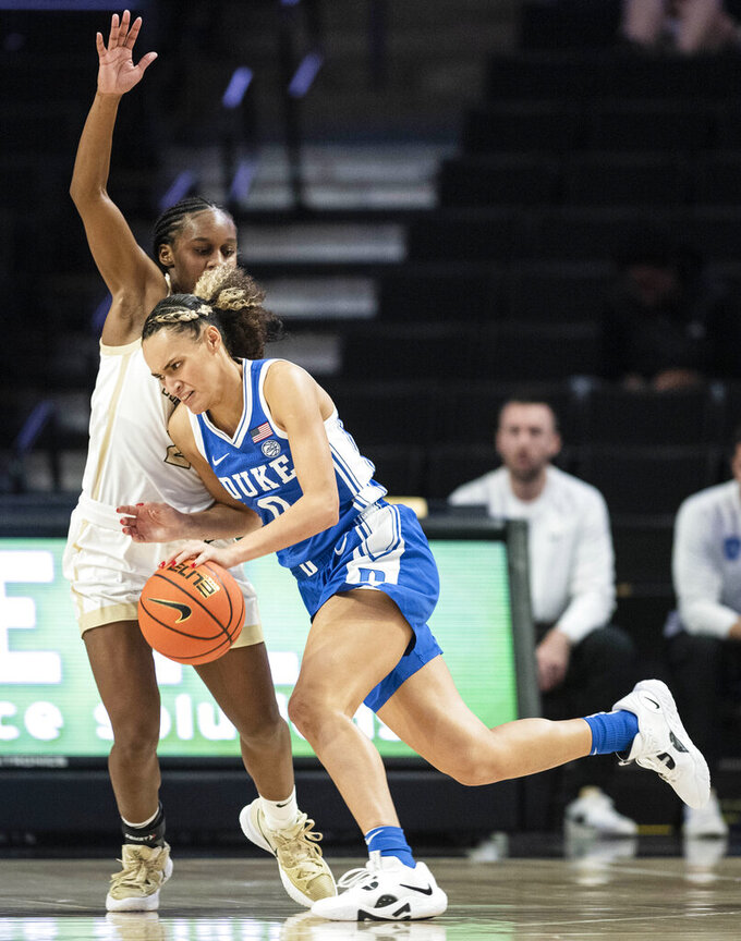 FILE -  Duke guard Celeste Taylor (0) pushes her way past Wake Forest guard Kaia Harrison, left, in the second half of an NCAA college basketball game Thursday, Jan. 5, 2023, in Winston-Salem, N.C. With Duke rising to No. 9 in this week's AP Top 25, it marks only the second time since 2000 that each of neighboring schools Duke, North Carolina and North Carolina State have cracked the top 10 in the same season. (Allison Lee Isley/The Winston-Salem Journal via AP, File)