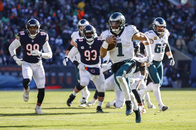 FILE — Philadelphia Eagles quarterback Jalen Hurts (1) runs to score a touchdown during the first half of the team's NFL football game against the Chicago Bears on Dec. 18, 2022, in Chicago. (AP Photo/Kamil Krzaczynski, File)