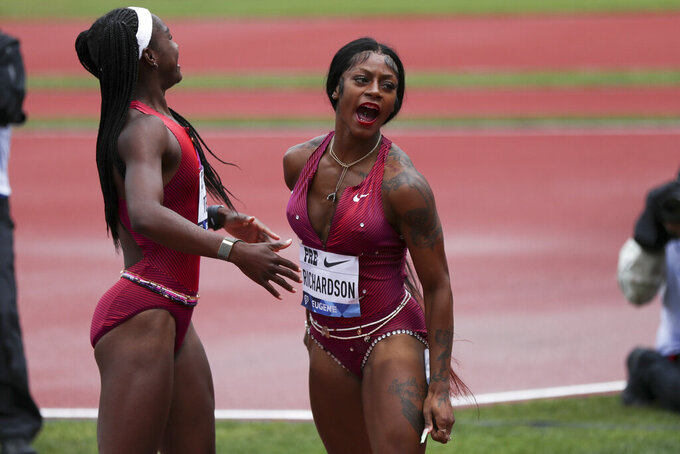 United States' Sha'Carri Richardson, right, celebrates her second-place finish in the women's 100 meters during the Prefontaine Classic track and field meet Saturday, May 28, 2022, in Eugene, Ore. (AP Photo/Amanda Loman)