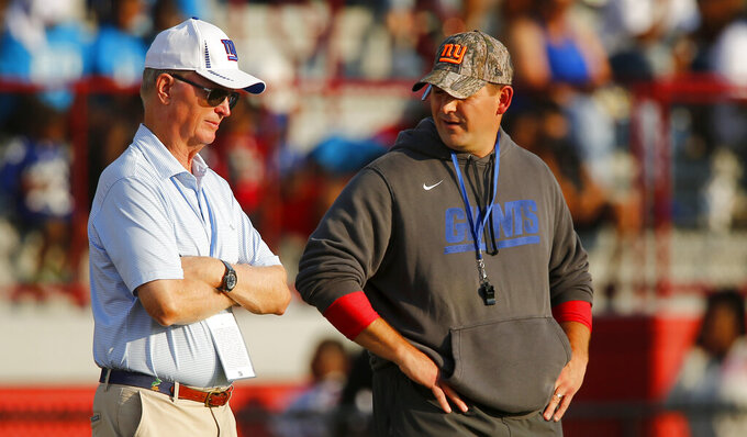 FILE - New York Giants coach Joe Judge, right, looks toward team president John Mara talk during the NFL football team's training camp on July 31, 2021, in Newark, N.J. The low point in New York Giants co-owner John Mara’s more than 30-year association with the franchise was seeing the team's struggles in a four-win season that led to the retirement of general manager Dave Gettleman and the firing of coach Joe Judge.  (AP Photo/John Munson, File)