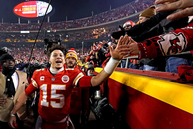 Kansas City Chiefs quarterback Patrick Mahomes (15) celebrates with fans after an NFL divisional round football game against the Buffalo Bills, Sunday, Jan. 23, 2022, in Kansas City, Mo. The Chiefs won 42-36 in overtime. (AP Photo/Charlie Riedel)
