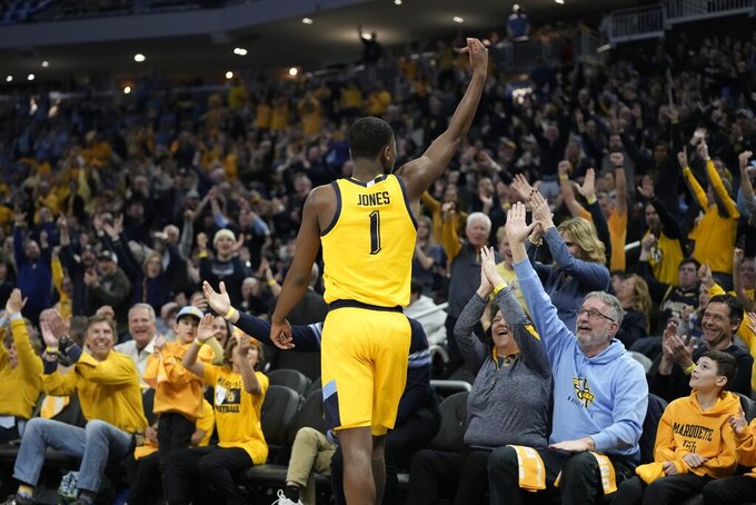 Marquette's Kam Jones reacts after making a three pointer at the buzzer during the first half of an NCAA college basketball game against Butler Saturday, Feb. 4, 2023, in Milwaukee. (AP Photo/Morry Gash)