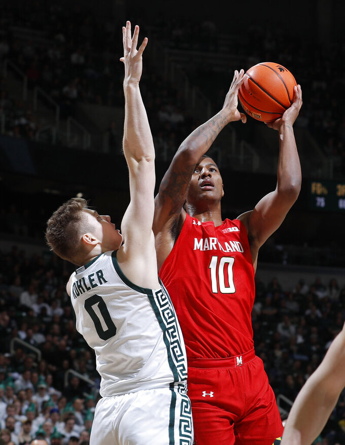 Maryland's Julian Reese, right, shoots against Michigan State's Jaxon Kohler during the first half of an NCAA college basketball game, Tuesday, Feb. 7, 2023, in East Lansing, Mich. (AP Photo/Al Goldis)