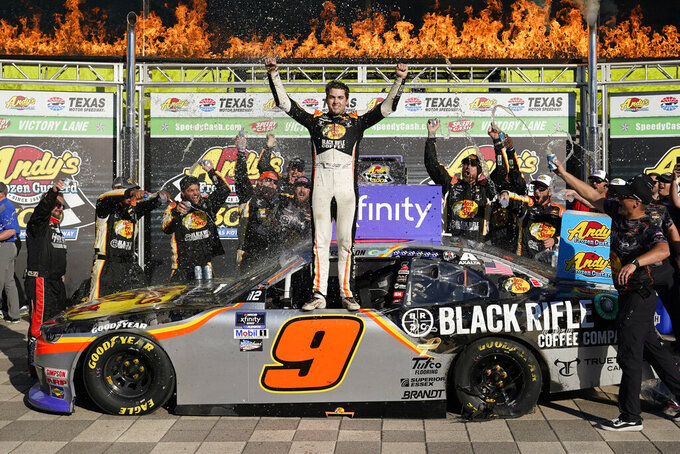 Noah Grayson (9) celebrates with his crew in Victory Lane after winning the NASCAR Xfinity Series auto race at Texas Motor Speedway in Fort Worth, Texas, Saturday, Sept. 24, 2022. (AP Photo/LM Otero)
