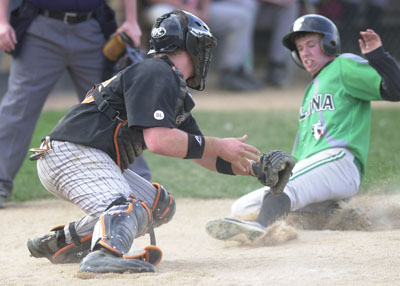 Coldwater catcher Trent Gerlach, left, turns to tag out Celina's Brad Niley, right, who was trying to score on the play. Gerlach also had three doubles at the plate to help Coldwater defeat Celina, 7-6.<br>dailystandard.com