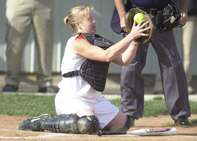 Coldwater's Katie Homan grabs the ball to make a play. The senior tagged out Marion's Dana Hartings at the plate in the second inning to keep the game scoreless.<br>dailystandard.com