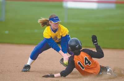 Marion Local's Lynn Hartke, left, puts a tag on Minster's Val Bornhorst, 14, during their Division IV sectional semifinal contest at New Bremen. Marion Local defeated Minster 2-0 and will face top-seeded New Bremen on Monday.<br>dailystandard.com