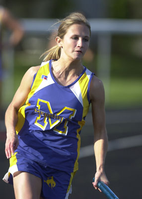 St. Marys' Hannah Brautigam turns the corner during the 400-meter relay during Friday's meet at Celina.<br>dailystandard.com