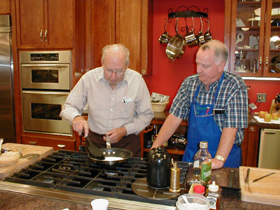 Cooking instructor Bob Marchal, right, guides Bob Byrum of Greenville through the steps of cooking quesadillas. Byrum, 86, and twice a widower, may not be a Julia Child but he can stir up a tasty lunch.<br>dailystandard.com