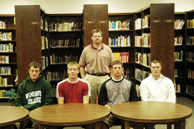 Four Marion Local football players will continue to play football next season in college. The players that made their choices are, from left, Kyle Hartings (Wilmington College), Matt Prenger (Wittenberg University), Eric Schroeder and Brent Prenger (Ohio Northern). Standing in the back is Marion head football coach Tim Goodwin.<br>dailystandard.com