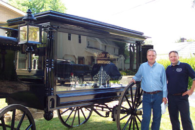 The Miller Brothers, Brent at left and Kent, polish a vintage hearse in preparation for today's 4:30 p.m. Summerfest Parade in St. Marys. The men, part of a family corporation that owns funeral homes in St. Marys and New Knoxville, purchased the 125-year-old vehicle a year ago and launched restoration efforts. They plan to use it for area parades as well as funeral processions.<br>dailystandard.com