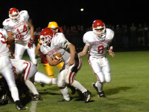 St. Henry's Andy Puthoff, with ball, takes the handoff from quarterback Nate Stahl, 8, during Friday's game. St. Henry defeated New Bremen, 20-14.<br>dailystandard.com