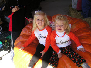 Taylor Paul, 2, and Ashton Heitkamp, 3, both of New Bremen, found a comfy spot Sunday on a 400-pound pumpkin at the first annual Giant Pumpkin Weigh Off. Next year's competition is already set for Oct. 2, 2005.<br>dailystandard.com