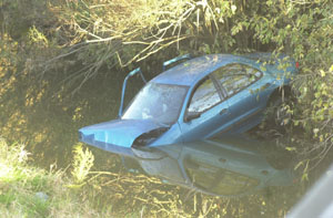 Brittany Shaffer, 15, of Mendon, was killed Tuesday afternoon after she was ejected from the Chevrolet Cavalier, above, shown partially submerged in Kyle Prairie Creek on Tomlinson Road in northern Mercer County. The driver of the car, Trisha Strawn, 17, also of Mendon, is in serious condition at Parkview Memorial Hospital, Fort Wayne, Ind. <br>dailystandard.com
