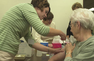 Celina resident Alice Hellwarth receives a flu shot Tuesday morning from Mercer County Health Department Nursing Director Sally Bowman. The clinic was the last scheduled flu shot clinic for high risk residents and exhausted the county's flu vaccine supplies.<br>dailystandard.com