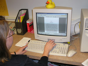 Mary Jo Stilwell, public relations coordinator at St. Marys Community Public Library, calls up an e-book on her computer to demonstrate the on-screen image looks like a real book page. <br>dailystandard.com