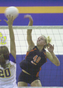 Coldwater's Karla Niekamp, 40, spikes the ball past St. Marys' Anna Laird, 20, during their match on Monday night.<br>dailystandard.com
