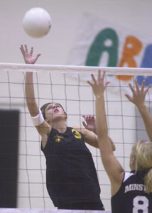 Parkway's Laura Art, 3, tips the ball over the net during the Panthers' match against Minster on Thursday night. Minster defeated Parkway in the season finale for both teams, 25-22, 25-22, 26-24.<br>dailystandard.com