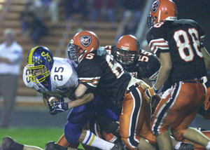 Coldwater's Greg Kleinhenz, 65, puts the hit on Delphos St. John's running back Curtis Laudick, 25, during their game on Friday night. Coldwater defeated Delphos St. John's, 14-7.<br>dailystandard.com