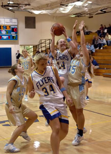 Marion Local's Kelsey Schaeffer, 34, tries to get out of the way as teammate Maria Moeller, 14 tries to score off the drive. Moeller had 20 points and nine assists in the Flyers' 64-41 win.<br>dailystandard.com