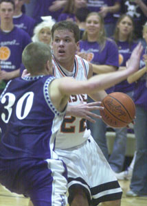 Minster's Dane Sommer, 22, is guarded closely by Fort Recovery's Dusty Tobe, 30, during their game on Friday night. Sommer scored 16 points to help the Wildcats to a 56-49 victory.<br>dailystandard.com