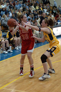 St. Henry's Kayla Lefeld, 30, keeps the ball away from Lehman's Ashley Jacob. Lefeld had nine points in the Redskins' loss.<br>dailystandard.com