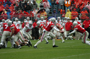 Ohio State quarterback Todd Boeckman, 17, hands the ball off to running back Erik Haw, far right, during the annual Scarlet and Gray spring game in Columbus on Saturday. Boeckman led Ohio State on three scoring drives during his time on the field.<br>dailystandard.com