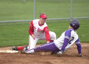 St. Henry's Sarah Osterholt, left, puts the tag down for an out on Fort Recovery's Brenda Rindler during their game on Wednesday. Fort Recovery went on to win, 4-2.<br>dailystandard.com
