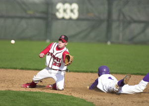 Fort Recovery's Todd Post, right, slides safely into second base ahead of the throw as St. Henry's Josh Werling, left, reaches for the ball. Fort Recovery defeated St. Henry, 8-2.<br>dailystandard.com