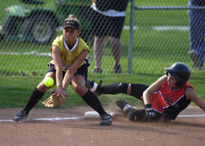 Versailles' Chelsea Mayer slides into third base safely as Parkway's Ashley Gamble waits for the ball. Parkway beat Versailles in a battle of Midwest Athletic Conference unbeatens, 6-1, to grab sole possession of first in the MAC standings.<br>dailystandard.com