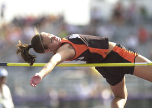 Minster's Amy Kremer glides over the bar during the high jump competition during Tuesday's first day of the Midwest Athletic Conference track meet held at Fort Recovery. Kremer took first place in the high jump with a mark of 5-7.<br>dailystandard.com
