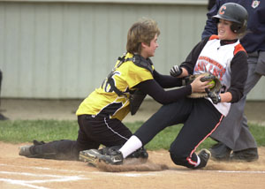 Parkway catcher Jayme Marbaugh, left, tags out Coldwater's Ashley Lefeld, right, during their Midwest Athletic Conference matchup on Thursday in Coldwater. Coldwater defeated Parkway 4-1 to spoil the Panthers' bid for a share of the MAC crown.<br>dailystandard.com