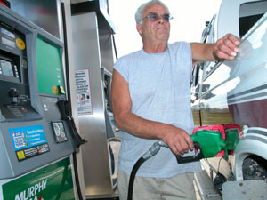 New Bremen resident Joe Wilson pumps fuel into his Ford 350 pickup truck Wednesday afternoon at Murphy USA in Celina. Lines formed quickly Wednesday at area gasoline stations as prices topped $3. Motorists fear higher prices lay ahead and fuel may not be available. It would cost nearly $90 to fill the tank of a Ford Expedition (SUV) at most area gasoline stations today.<br>dailystandard.com